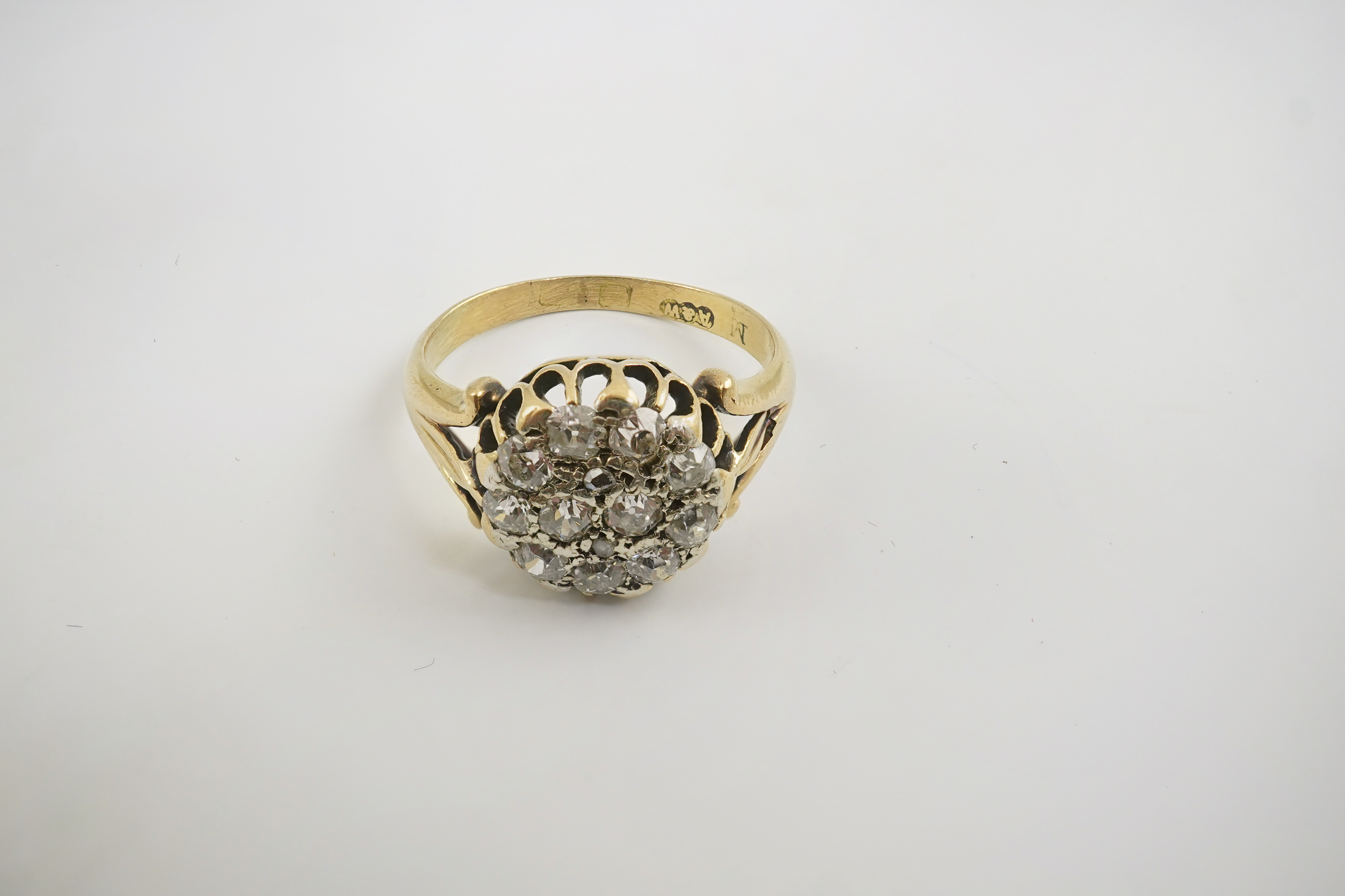 An early to mid 20th century gold and diamond set circular cluster ring